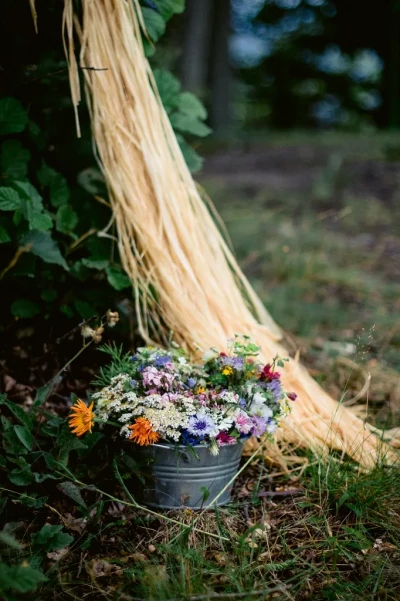Weinprobe Mosel: Eimer mit bunten Wiesenblumen als Dekoration im Weinberg